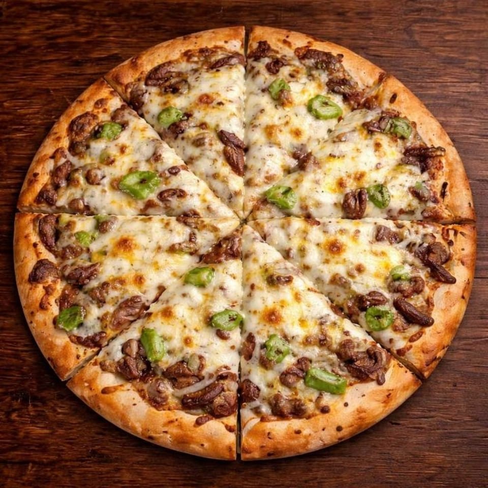 A sliced B Antonio's Pizza with melted cheese, mushrooms, and green peppers on a wooden table.